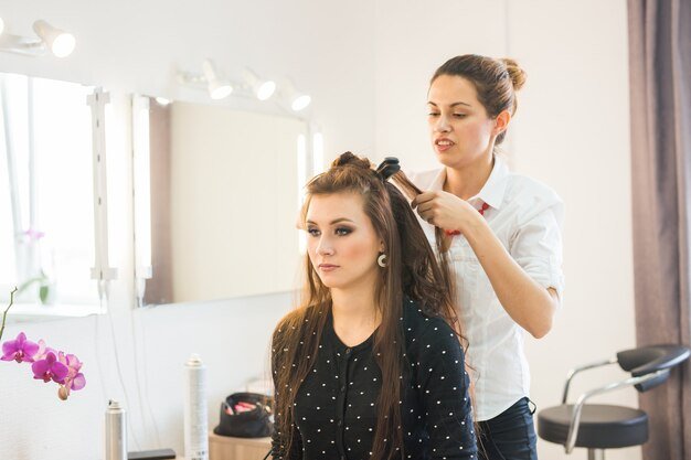 working-day-inside-beauty-salon-hairdresser-makes-hair-styling_230311-30061